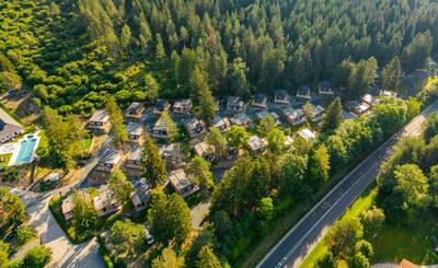 Aerial view of holiday homes next to a forest at the EuroParcs Pressegger See holiday park