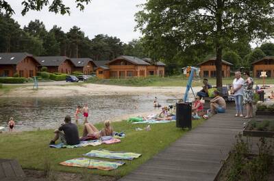 People relax at the recreational lake at the Europarcs de Achterhoek holiday park