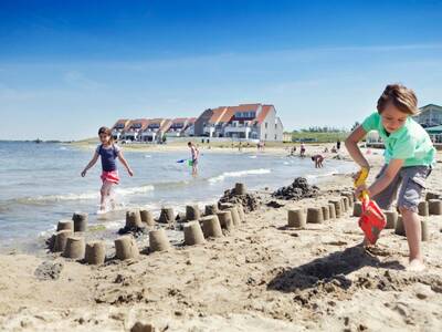 Children play on the beach at Landal Port Greve holiday park
