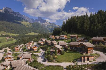 Luchtfoto van chalets op Alps Resorts Alpendorf Dachstein West, met daarachter bergen