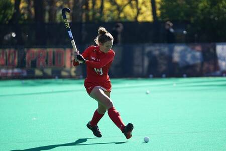 Vrouw aan het hockeyen op het hockeyveld op vakantiepark Brinckerduyn