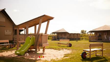 Speeltuin tussen glamping tenten op vakantiepark Dutchen Erfgoedpark de Hoop