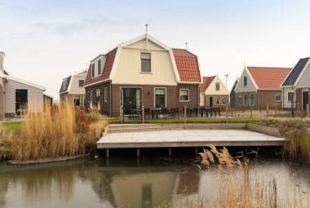 Een steiger aan het water bij een vakantiehuis op vakantiepark EuroParcs Poort van Amsterdam