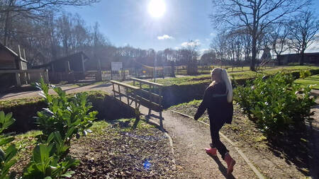 Een meisje wandelt richting de kinderboerderij op vakantiepark EuroParcs Ruinen