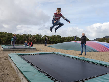 Kinderen springen op trampolines in de speeltuin op Landal Beach Park Grønhøj Strand