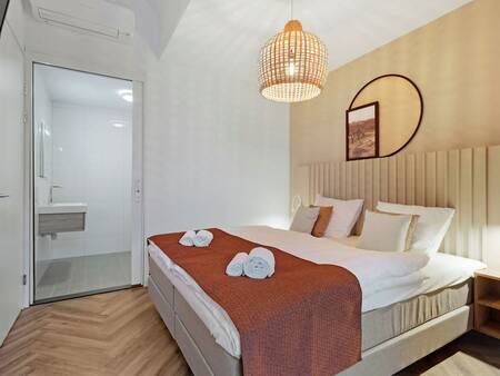 Slaapkamer met tweepersoonsbed van een appartement op Landal Kaap West