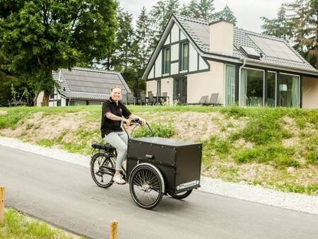 Vrouw met bakfiets voor vakantiehuizen op vakantiepark Landal Mont Royal