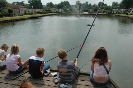 Kinderen aan het vissen in de visvijver op vakantiepark Landgoed De IJsvogel