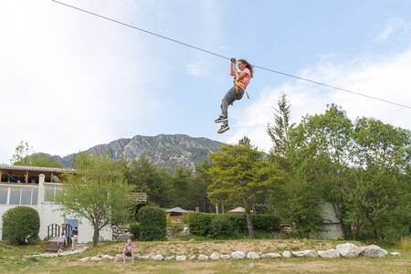 Meisje aan een tokkelbaan in het avonturenpark op vakantiepark RCN les Collines de Castellane