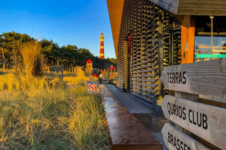 Centrumgebouw met op de achtergrond de speeltuin op vakantiepark Roompot Ameland