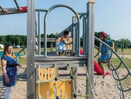 Kinderen spelen in de speeltuin op vakantiepark Roompot Duinresort Dunimar